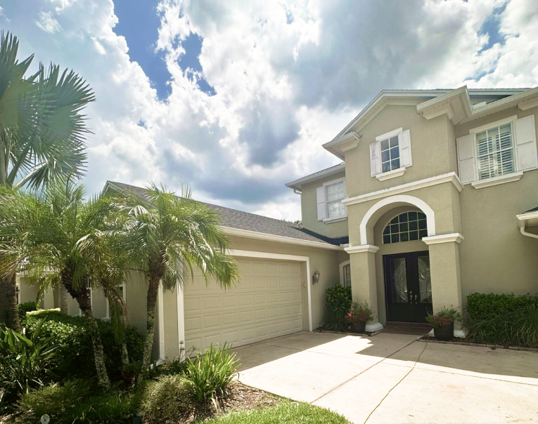 Happy homeowner with new gutters installed